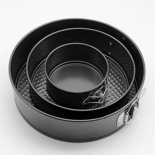 Set of three black springform pans on a white background