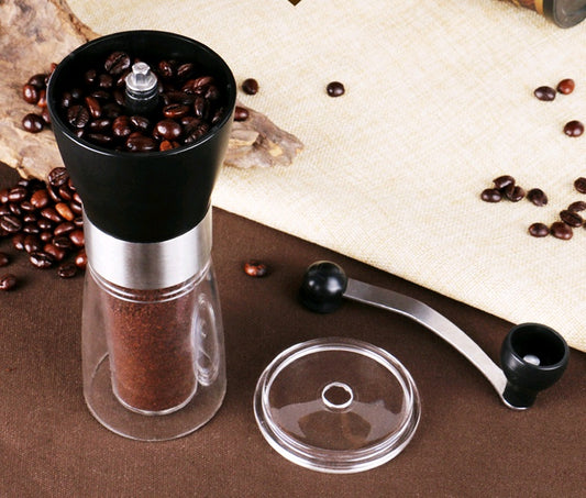 Coffee grinder with coffee beans on a wooden surface
