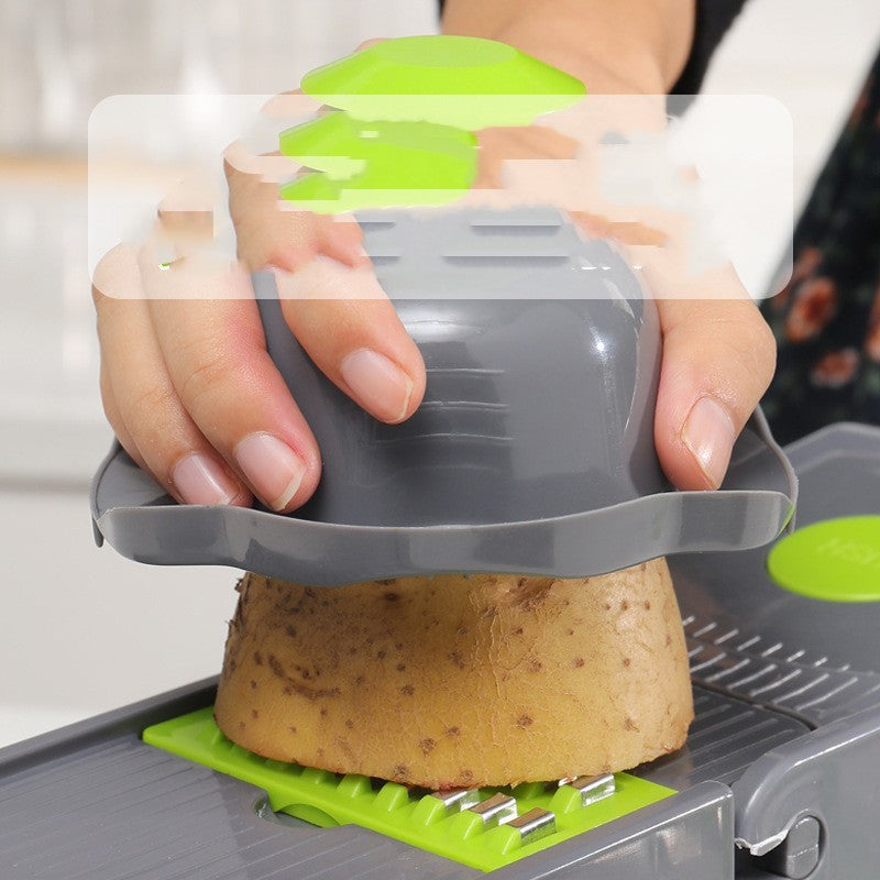 Person using a potato peeler on a potato with a blurred background