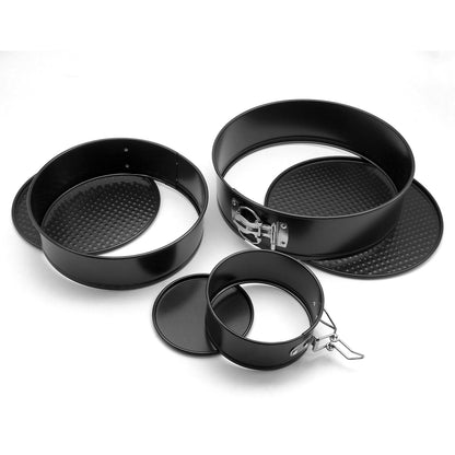 Set of black metal cake pans on a white background