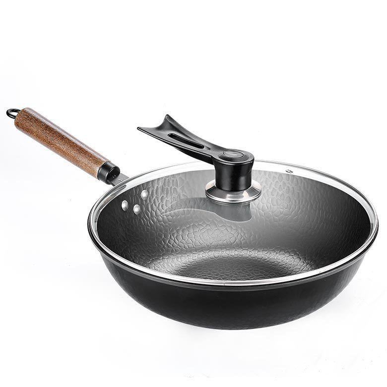Black frying pan with wooden handle and glass lid on a white background