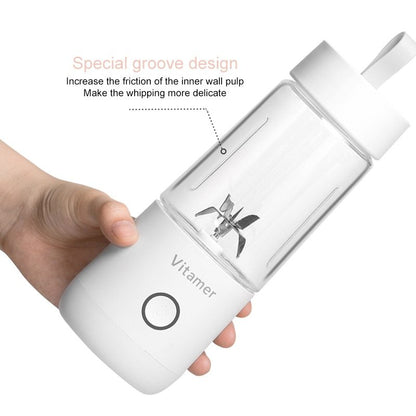 White kitchen appliance with 'Vitamer' branding, held by a hand, on a white background.