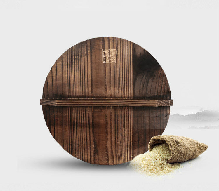 Wooden rice cooker with a small bag of rice on a light gray background