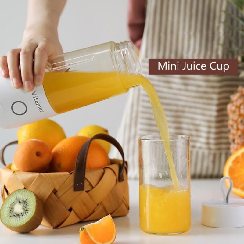Person pouring orange juice from a mini juice cup into a glass, with fruits and a basket in the background.