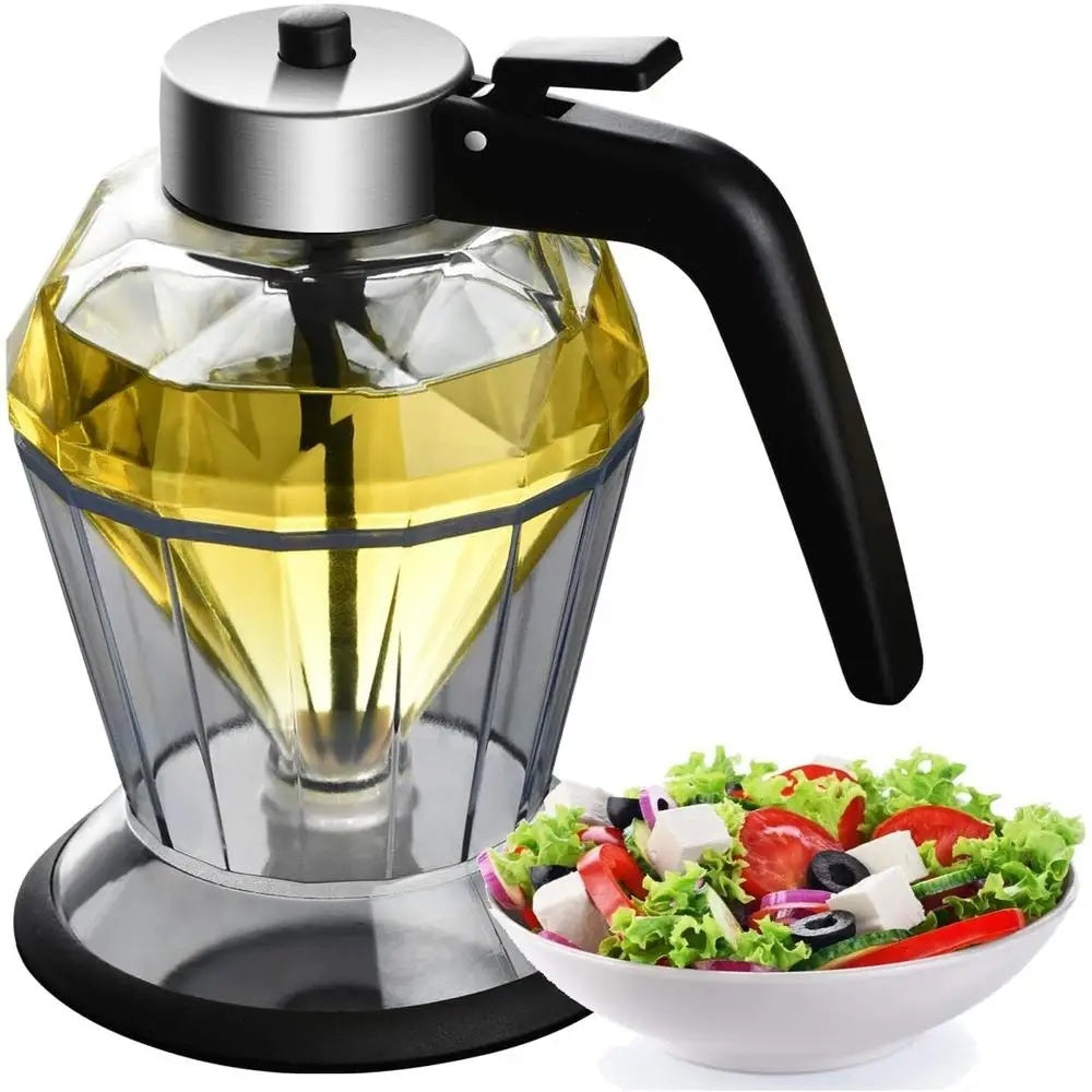 Glass oil dispenser with black handle next to a bowl of salad on a white background
