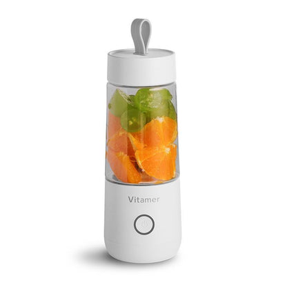 White portable blender with fruits inside on a white background