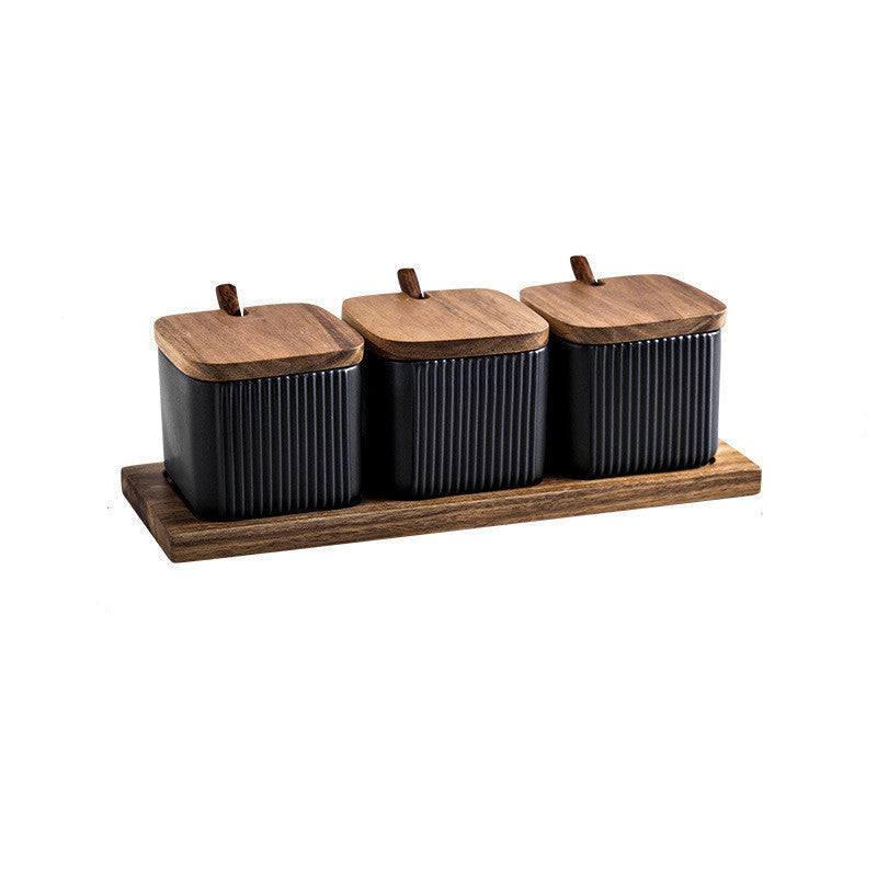 Set of three black canisters with wooden lids on a wooden tray, with measurements indicated.