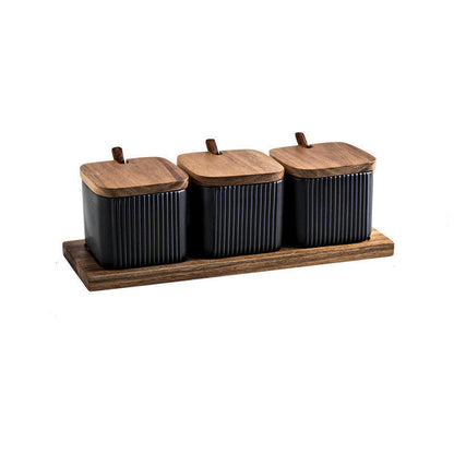 Set of three black canisters with wooden lids on a wooden tray, with measurements indicated.