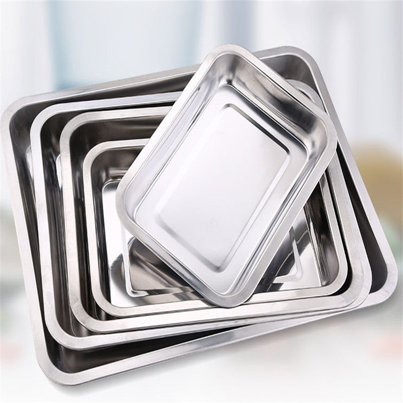 Set of stainless steel trays of different sizes on a light background