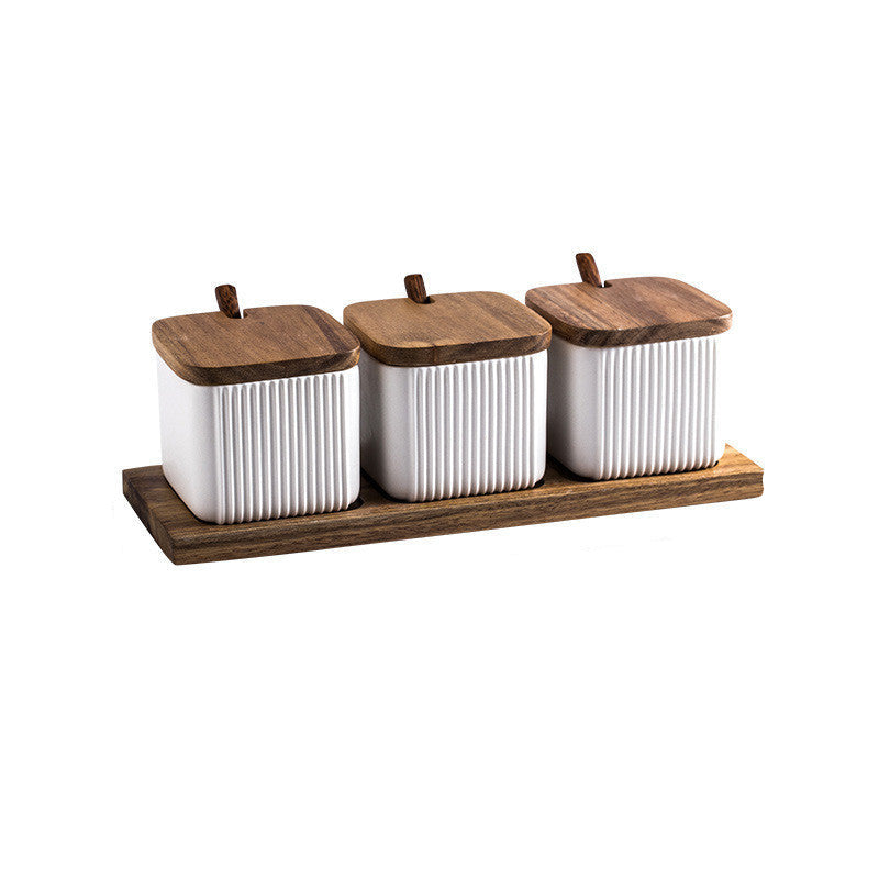 Three white canisters with wooden lids on a wooden tray, with measurements indicated.