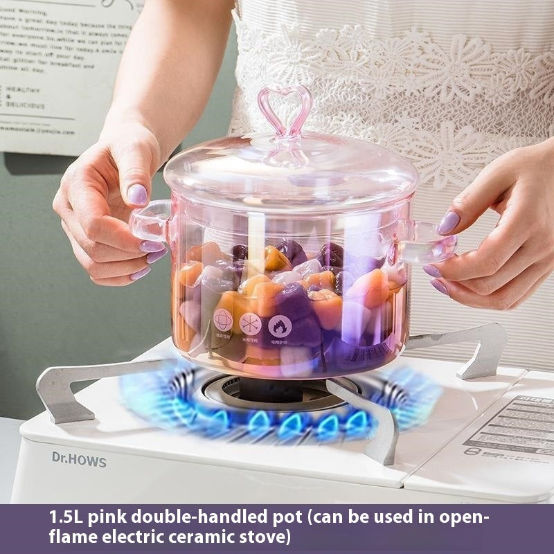 Person using a pink double-handled pot on an electric stove with colorful contents inside.