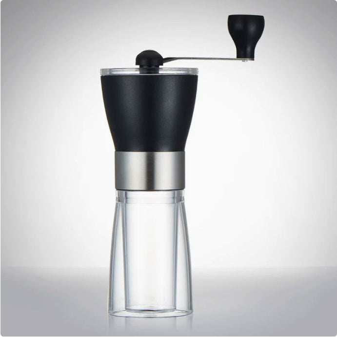Black and silver manual coffee grinder on a gray background