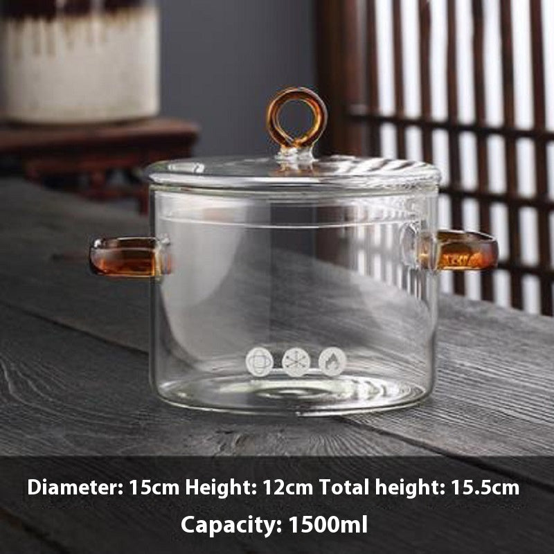 Clear glass jar with handles on a wooden surface