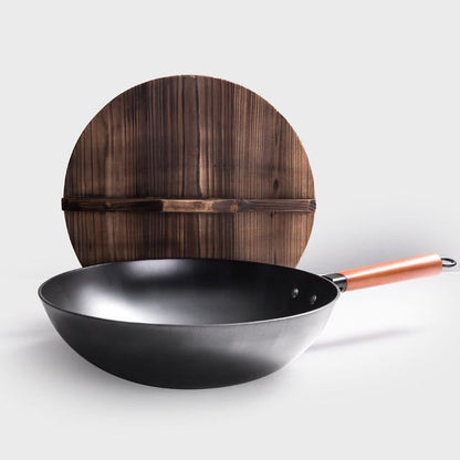 Black wok with copper handle and wooden lid on a light gray background