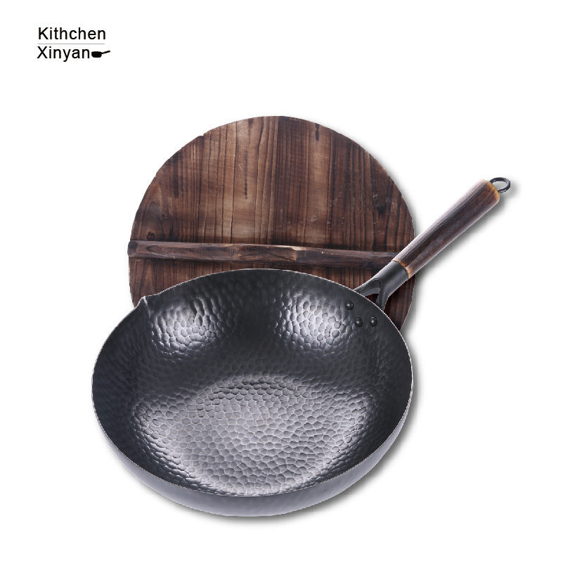 Black wok with wooden handle on a white background